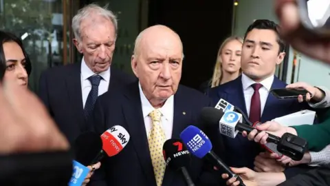 Veteran Australian Broadcaster Faces Downgraded Sexual Assault Charges